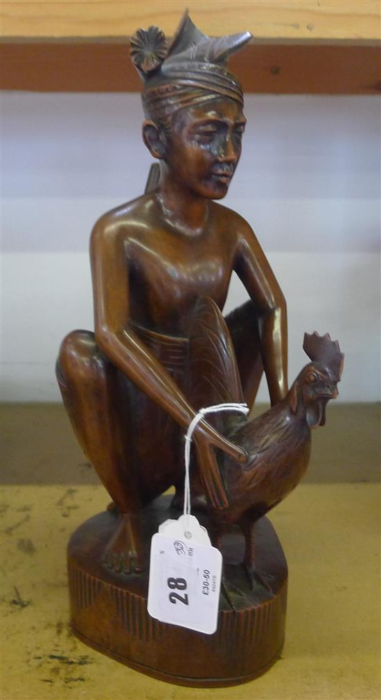 Hardwood figure with cockerel(-)